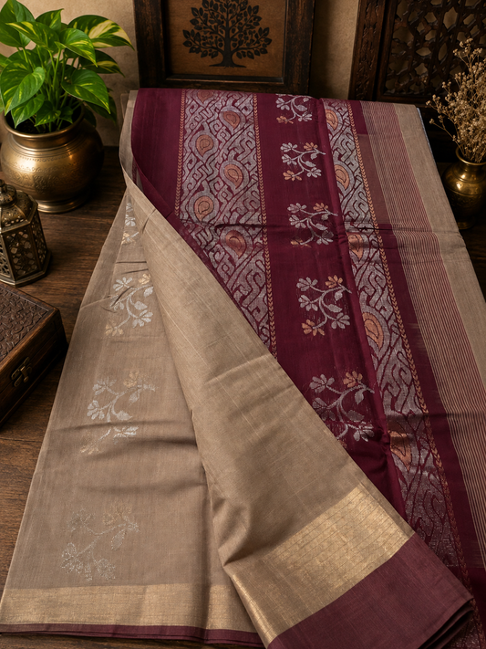 Beige handwoven cotton saree with golden and silver zari work with rich burgundy pallu